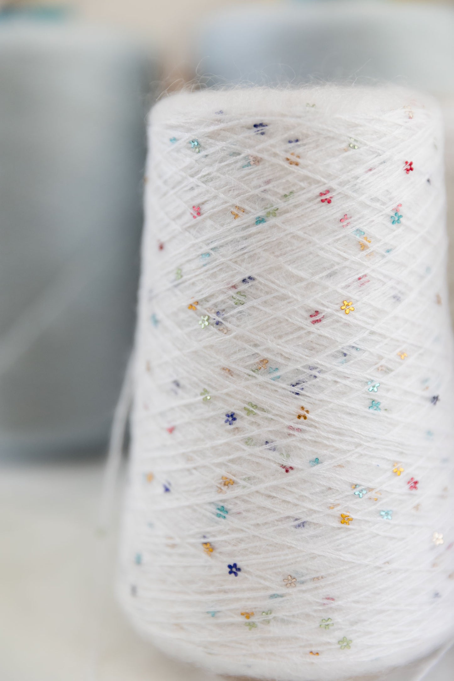 detail of a white mohair cone with sequins