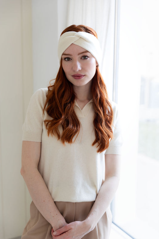 Woman wearing a white cashmere headband and cashmere top