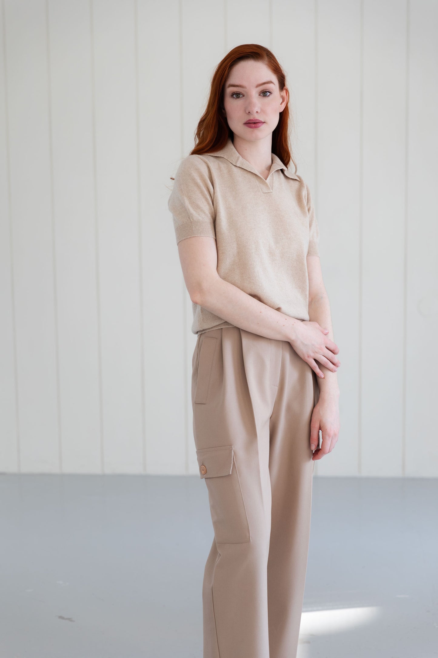 Woman wearing a 100% Mongolian cashmere polo shirt in beige.