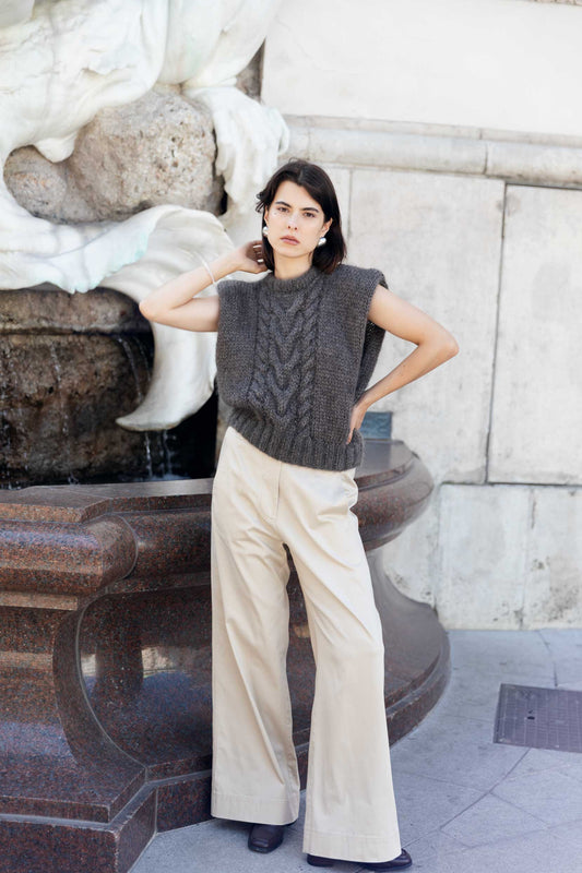Woman wearing a deep brown knitted sleeveless sweater vest