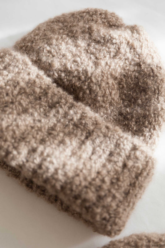 Handmade cashmere beanie knitted in Salzburg from Grade A Mongolian cashmere, featuring a soft bouclé texture and natural shape