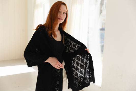 Woman wearing a black lace cashmere scarf