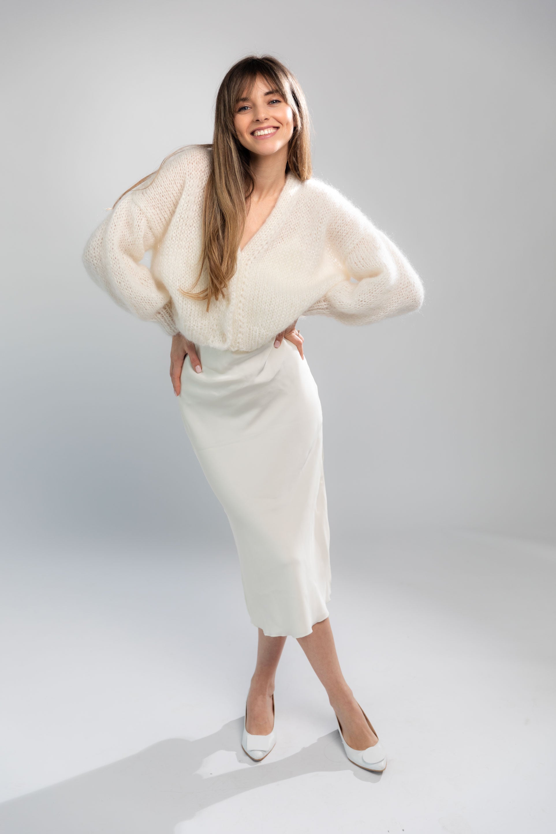 Handmade fluffy mohair cardigan, white color, with dropped shoulders and shell buttons. It has a voluminous and airy texture. Style it with high rise bottoms or a slip dress. Made from premium Italian yarn.