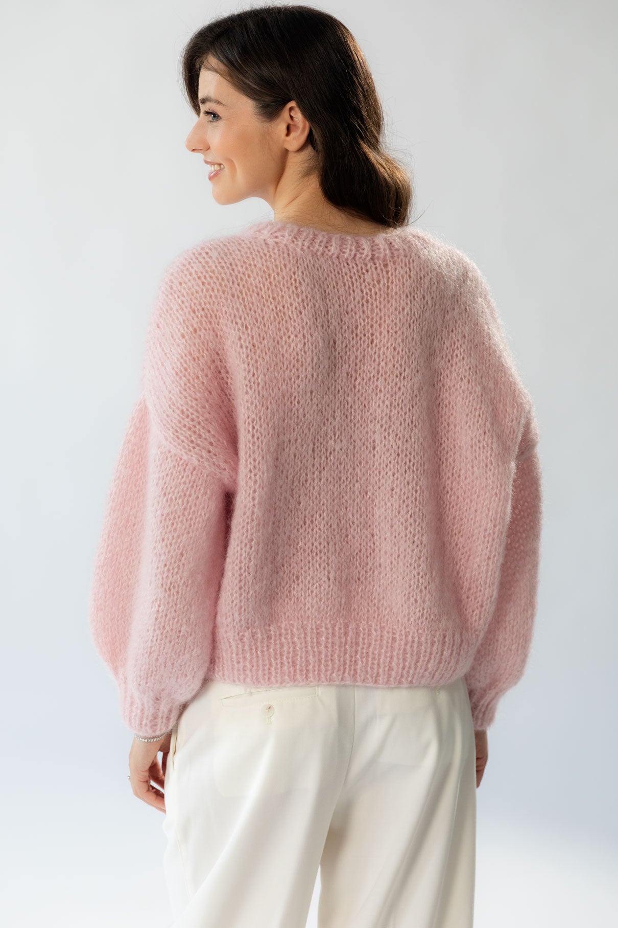 The Mohair Silk Sweater is an elegant handmade piece available in a delicate shade of pink. 