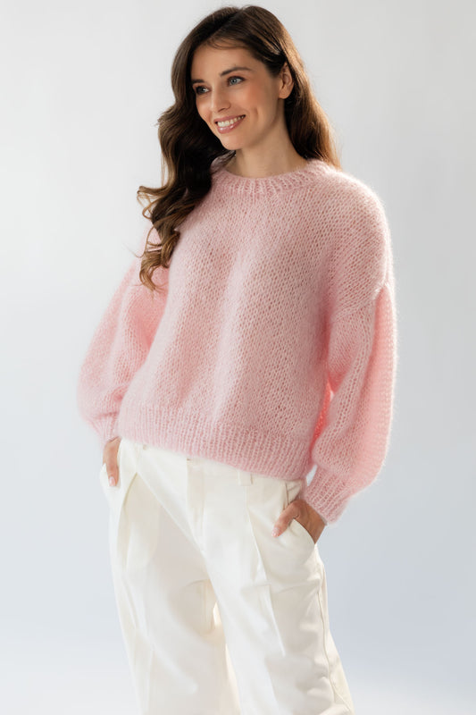The Mohair Silk Sweater is an elegant handmade piece available in a delicate shade of pink. 