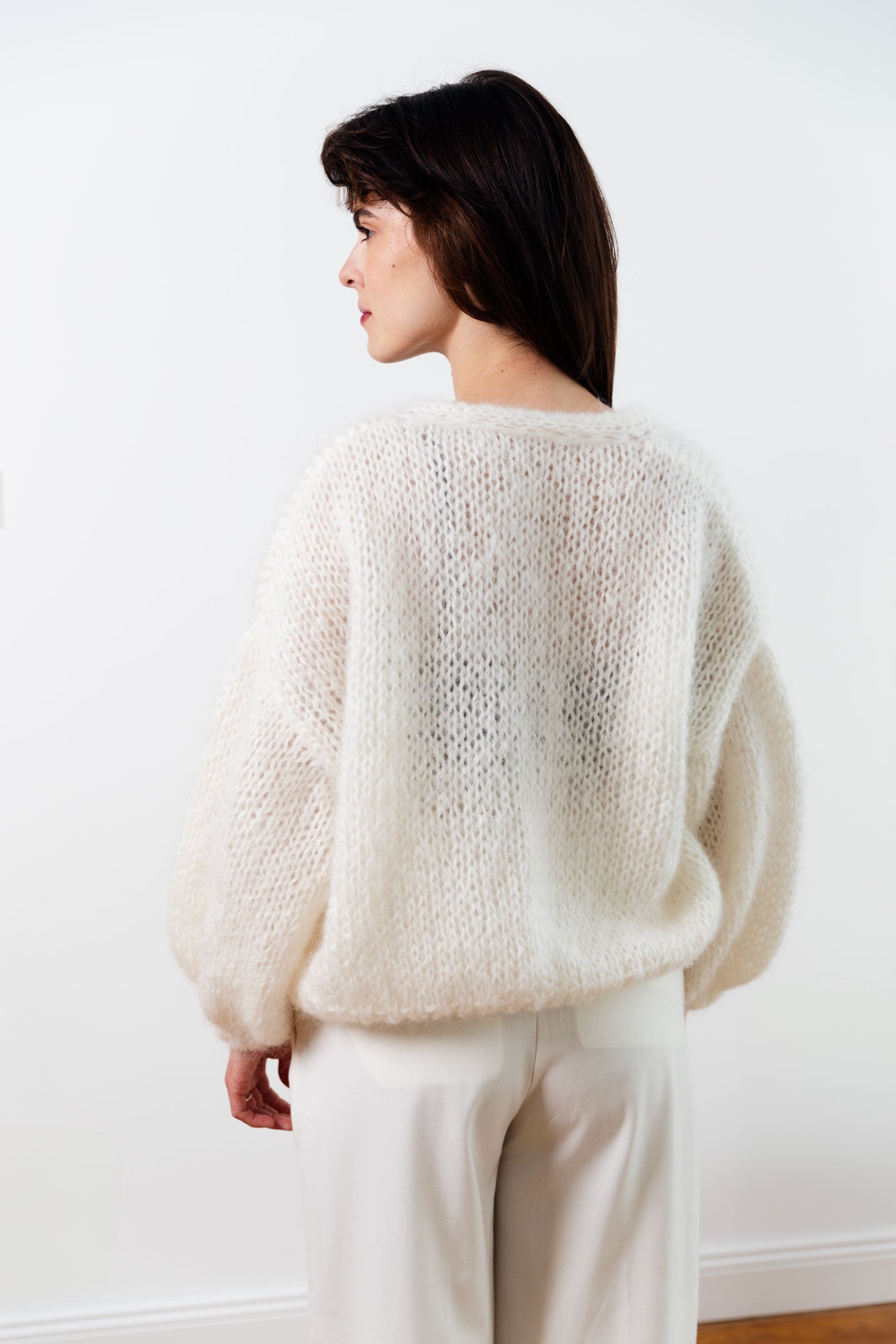 Handmade fluffy mohair cardigan, white colour, with dropped shoulders and balloon sleeves. It has a voluminous and airy texture. Style it with high rise bottoms or a slip dress. Made from premium Italian yarn.