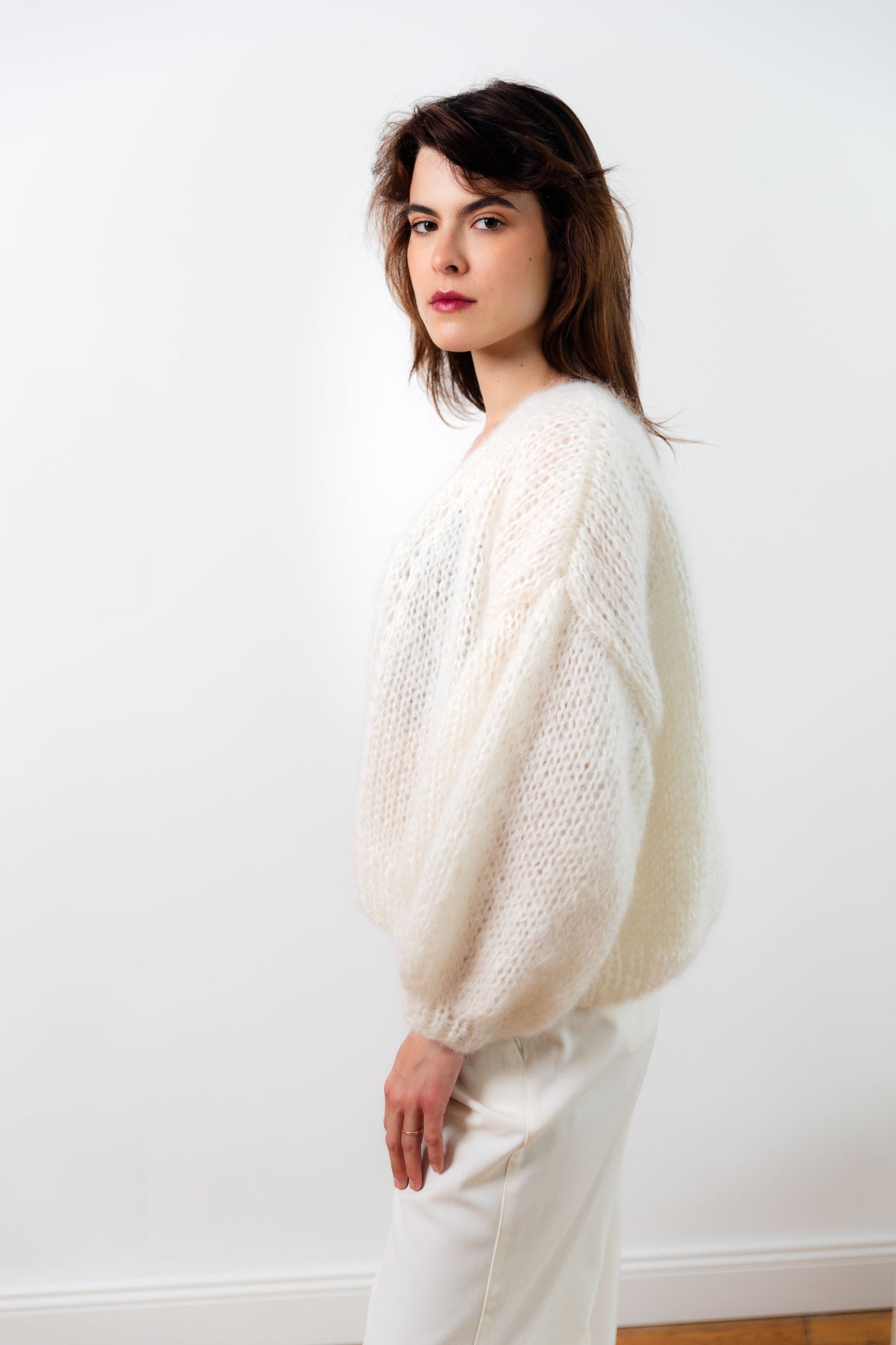 Handmade fluffy mohair cardigan, white colour, with dropped shoulders and balloon sleeves. It has a voluminous and airy texture. Style it with high rise bottoms or a slip dress. Made from premium Italian yarn.