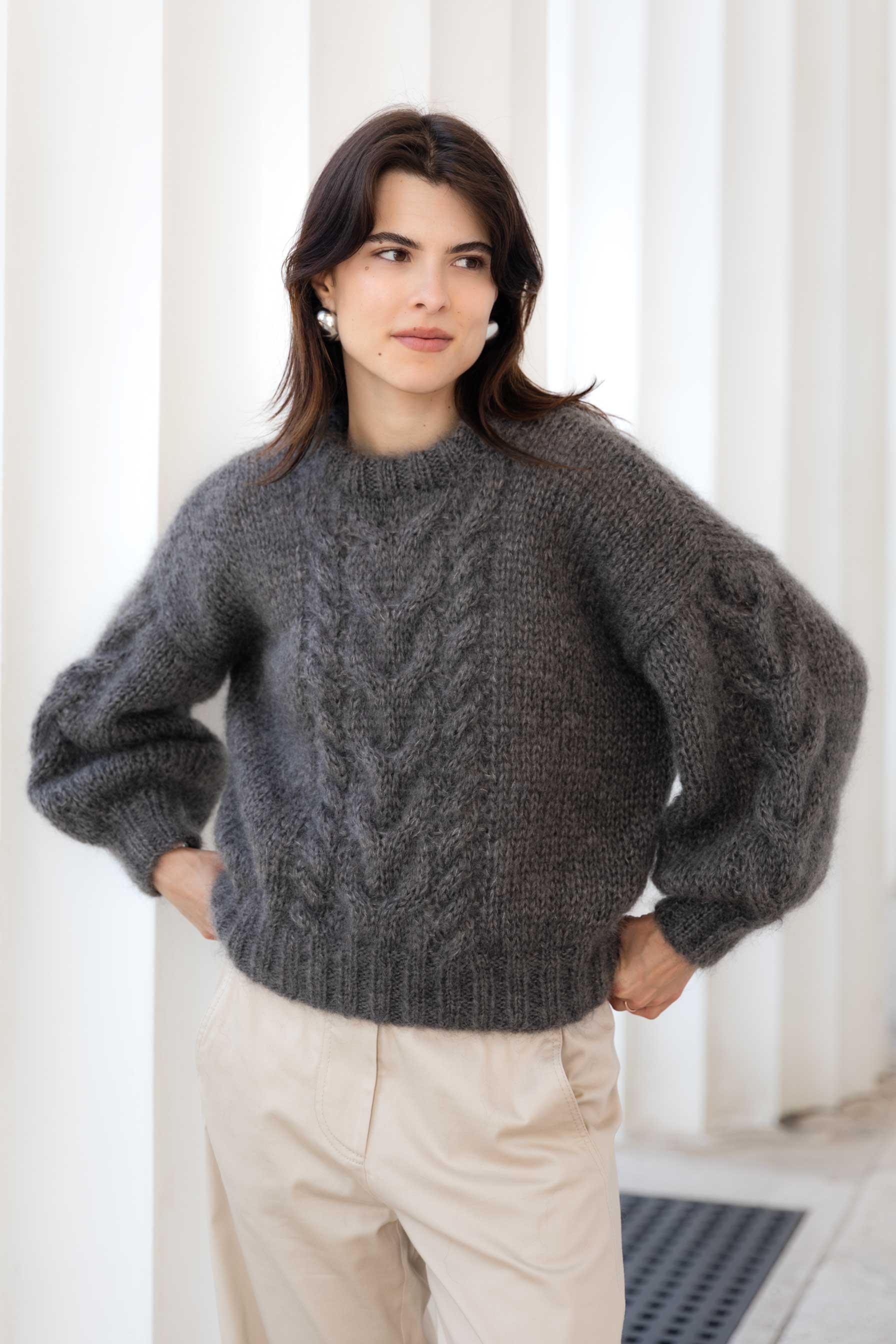 Woman wearing a brown mohair sweater with cable knit pattern