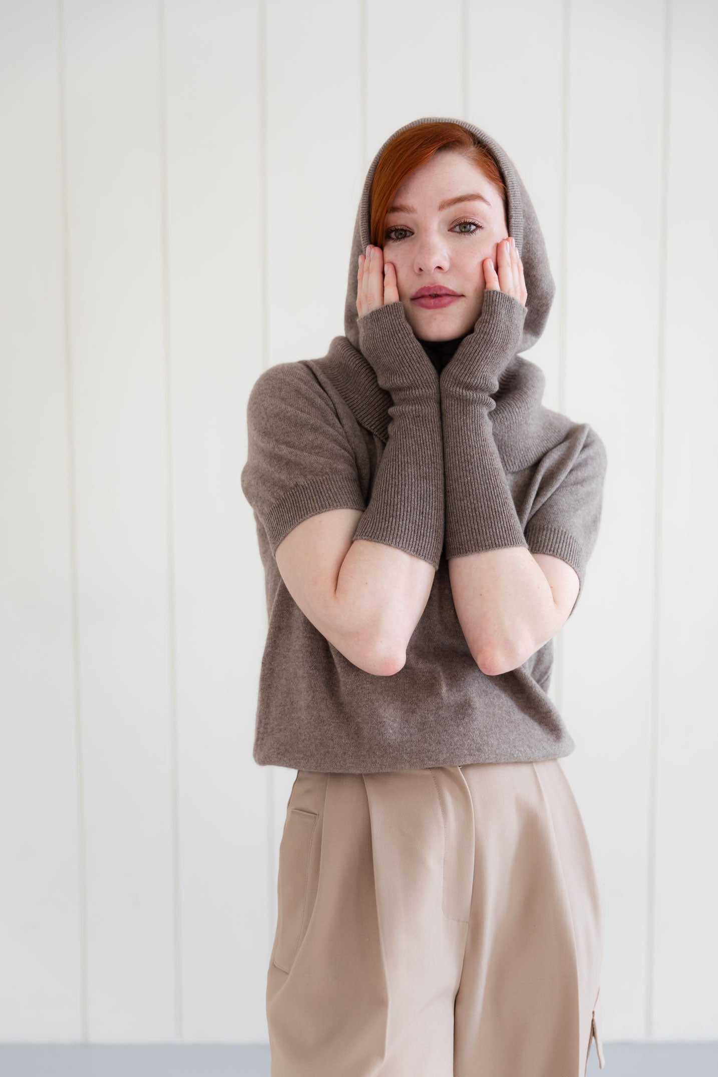Woman wearing cashmere arm warmers, and matching cashmere balaclava, and  cashmere short sleeve top