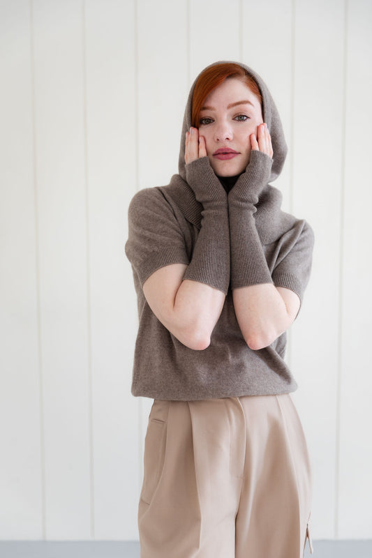 Woman wearing cashmere arm warmers, and matching cashmere balaclava, and  cashmere short sleeve top