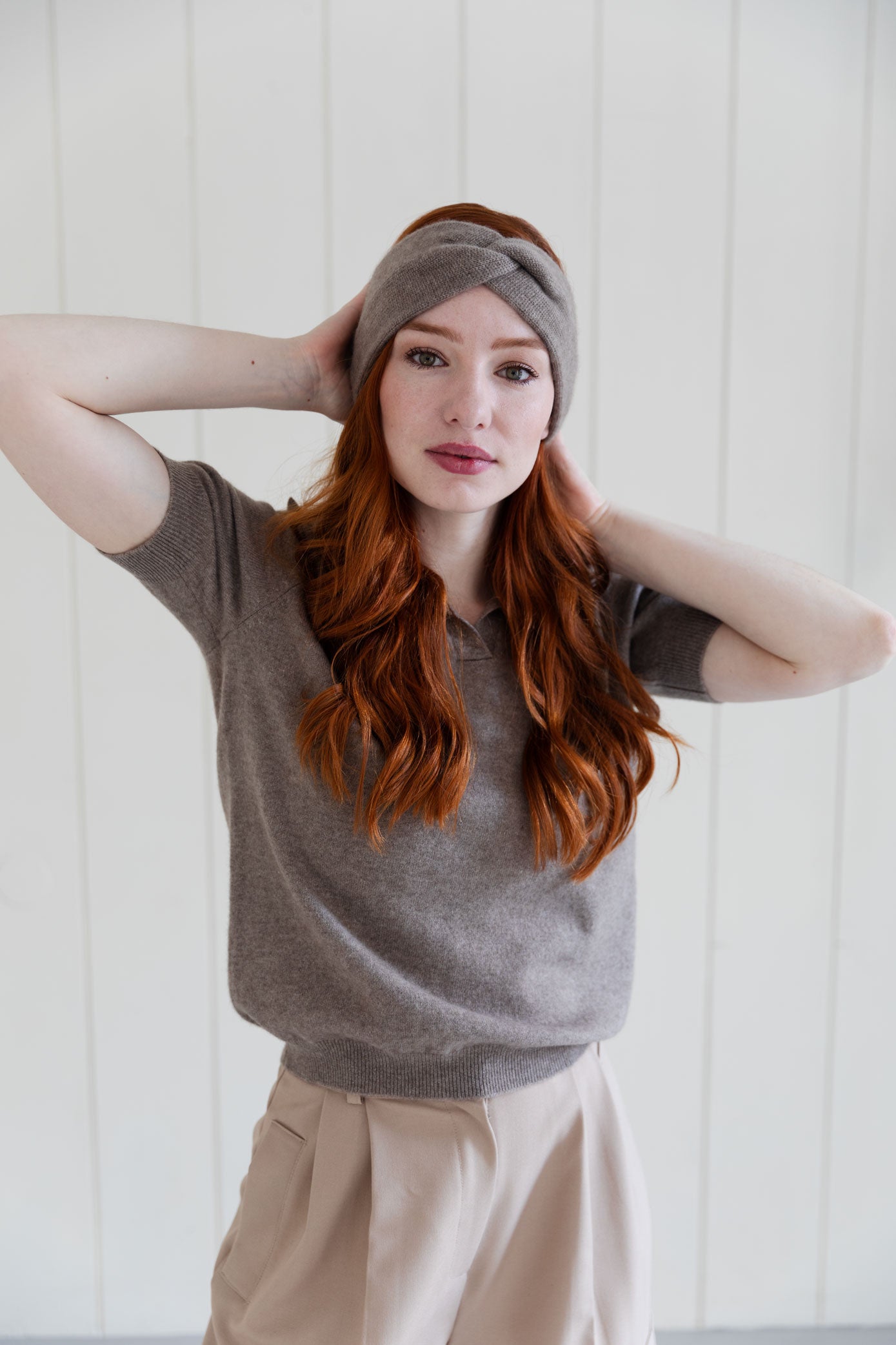 Woman wearing a taupe cashmere headband and a matching cashmere sweater