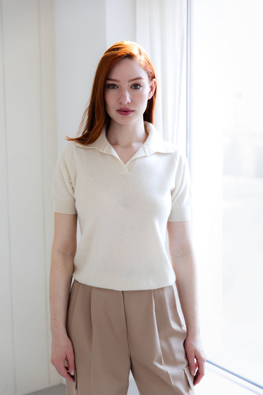 Woman wearing a white cashmere polo shirt