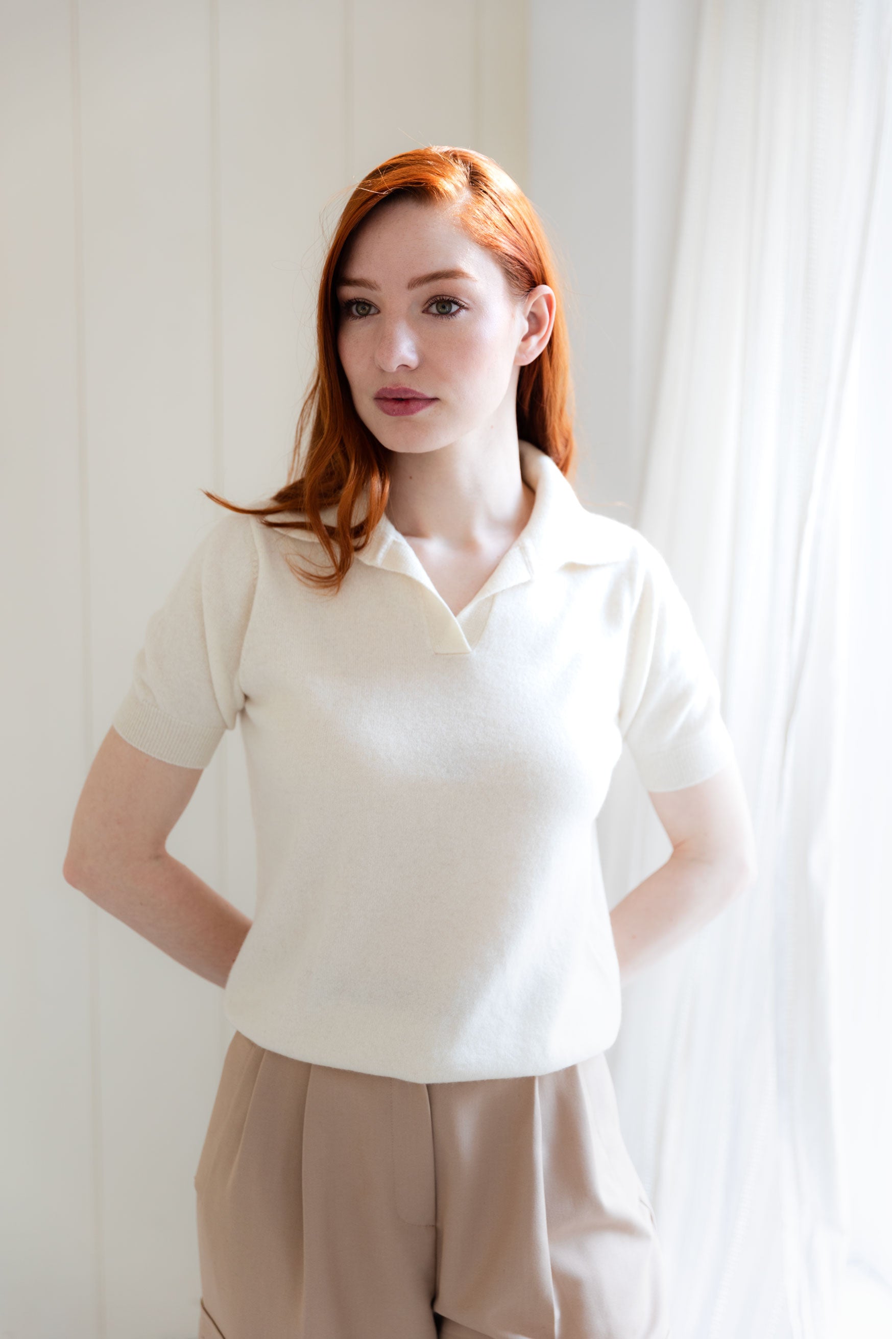 Woman wearing a white cashmere polo shirt