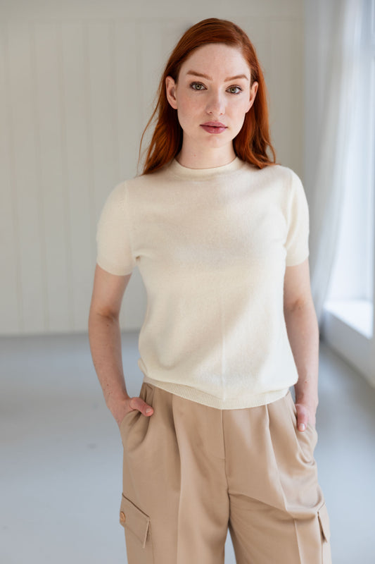 Woman wearing a 100% Mongolian cashmere t-shirt and beige pants.