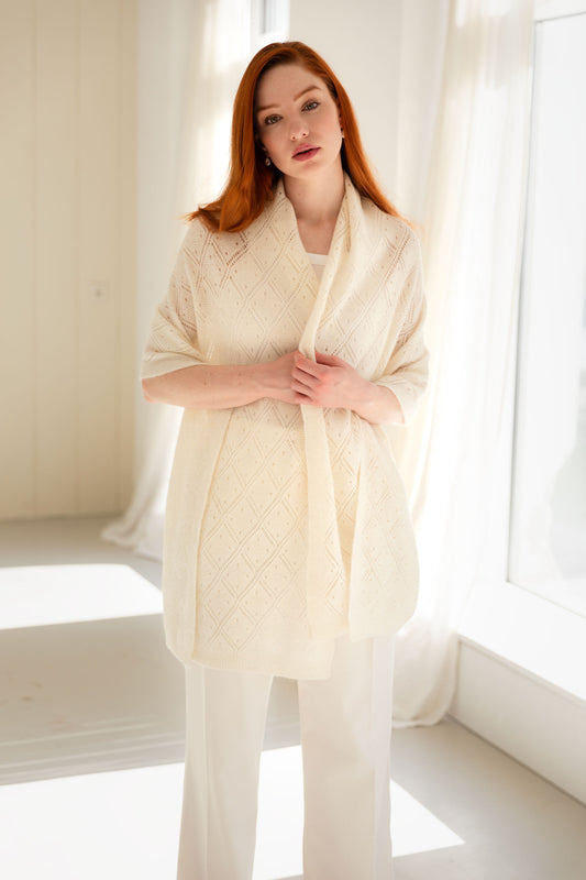 Woman wearing a white lace knit cashmere shawl