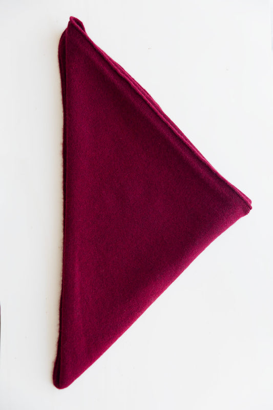 A folded burgundy cashmere triangle scarf, displayed on a clean white background.