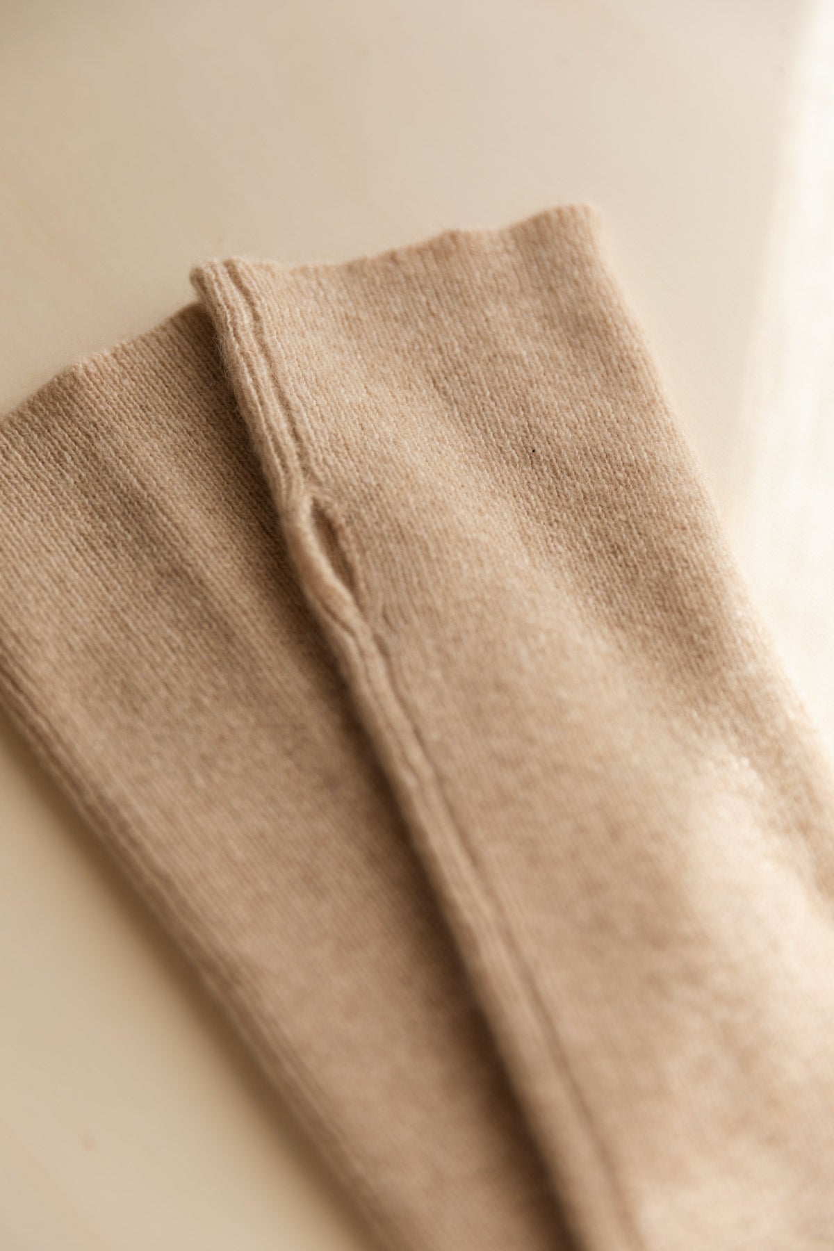 Close-up of beige cashmere arm-warmers