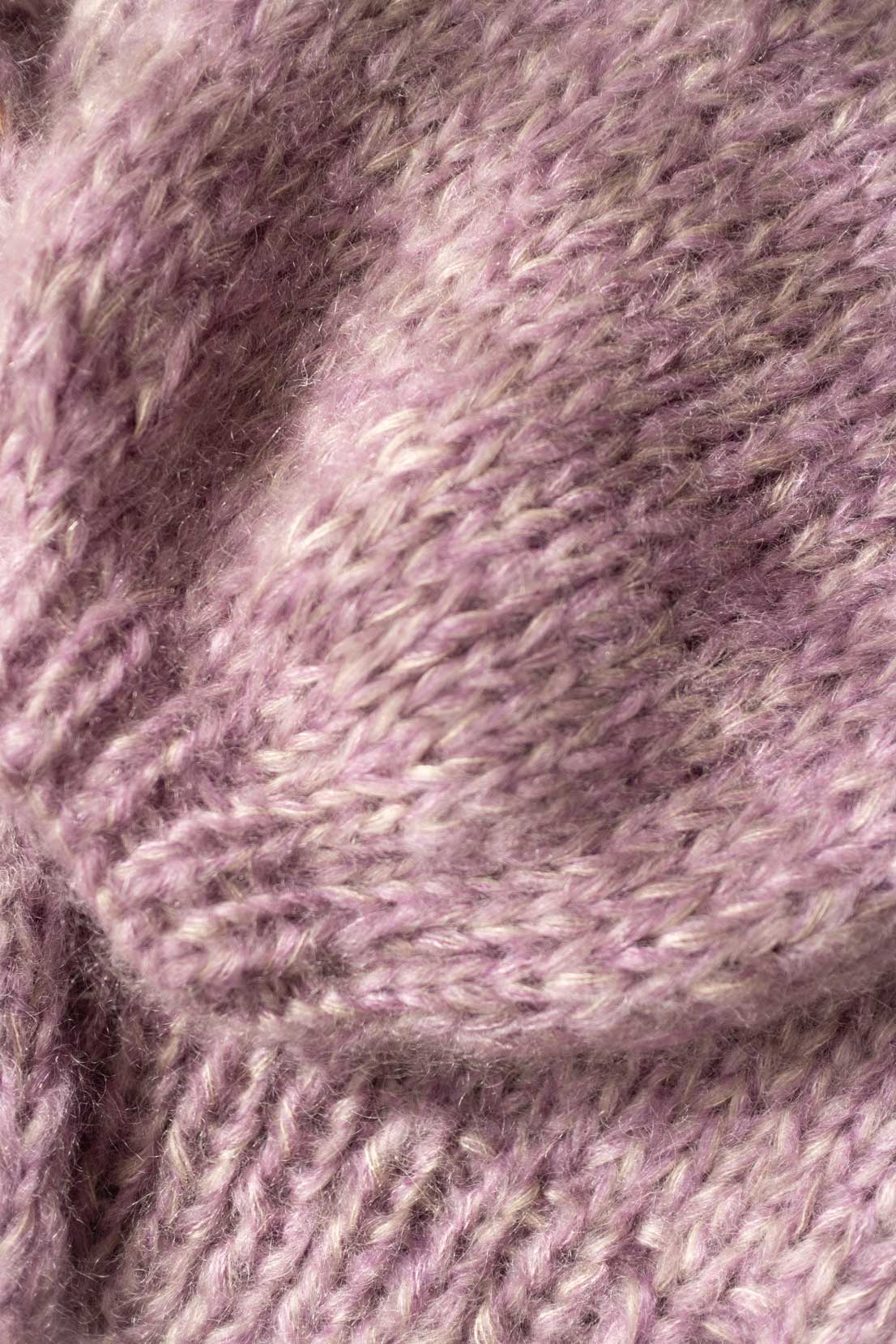 Close-up texture of a purple-beige mohair-silk blend cardigan showing the soft, fluffy knit fabric.